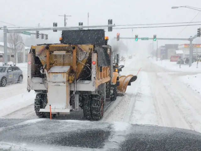A snowplow clearing U.S. 20 in Bend during a snowstorm