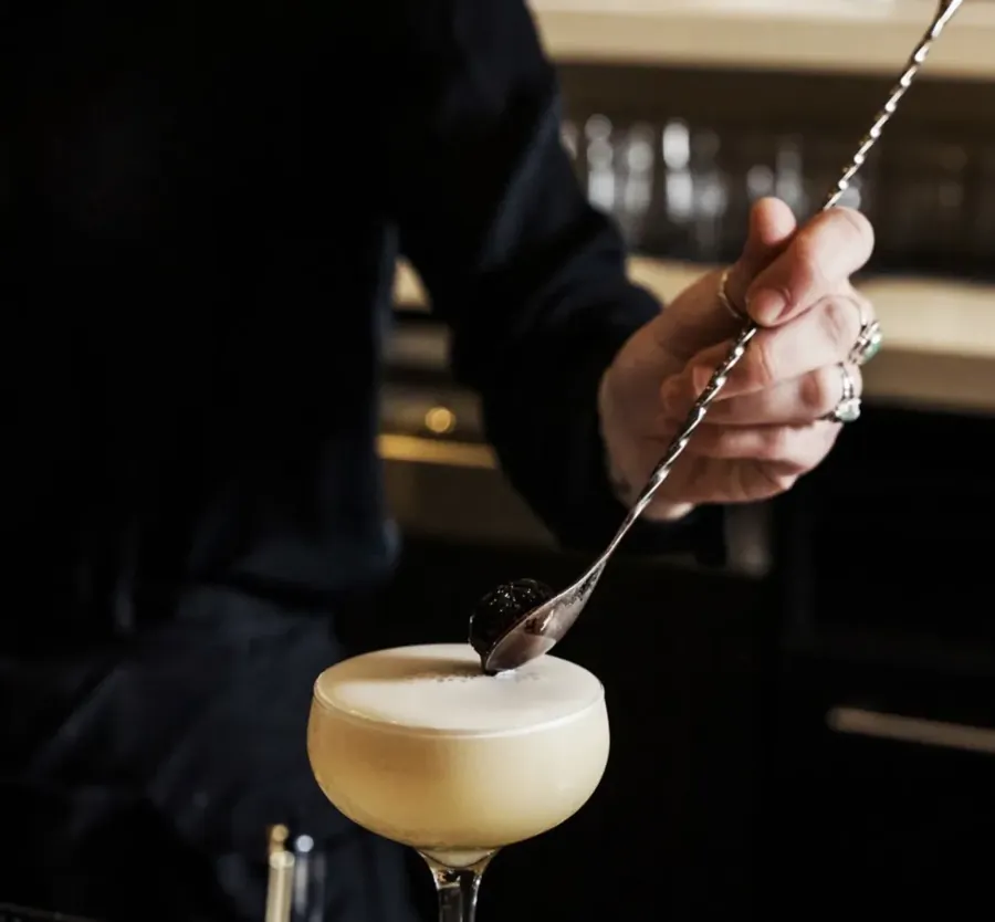 A bartender stirring a cocktail at the bar at 5 Fusion in downtown Bend