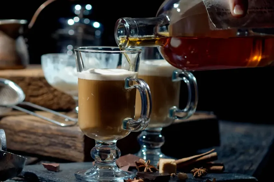 A hot drink being poured into glass mugs at Canteen bar at the Campfire Hotel in Bend