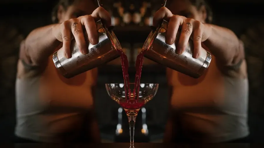 A cocktail being poured from two shakers at Dogwood at the Pine Shed