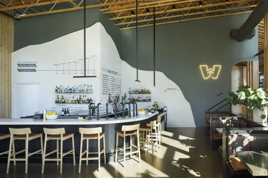 The white bar and stools at Hosmer in the Waypoint Hotel lobby in Bend