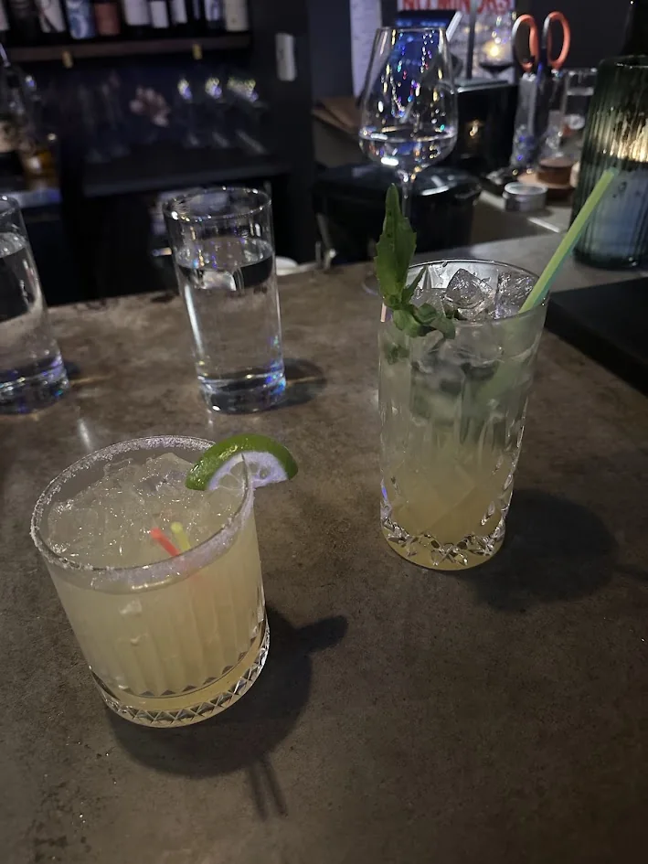 A salt-rimmed margarita and a mint cocktail on the bar at Portello Lounge in NorthWest Crossing, Bend, Oregon