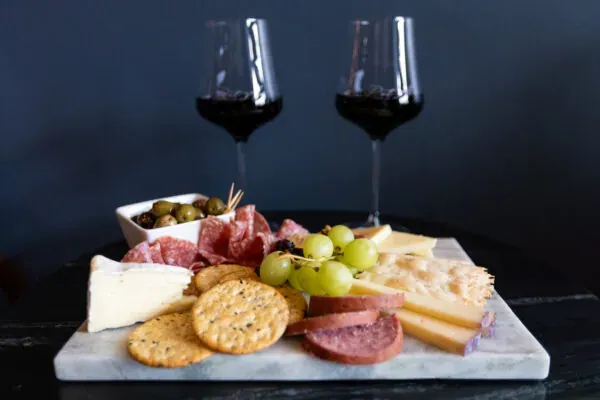 Two glasses of red wine and a charcuterie board at Put A Cork In It wine bar in Bend