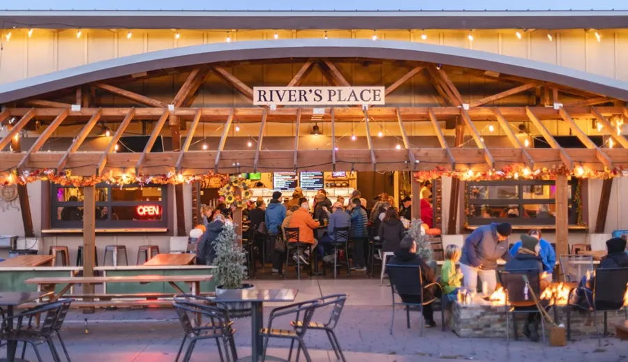 The covered patio at River’s Place taphouse in Bend lit up at dusk