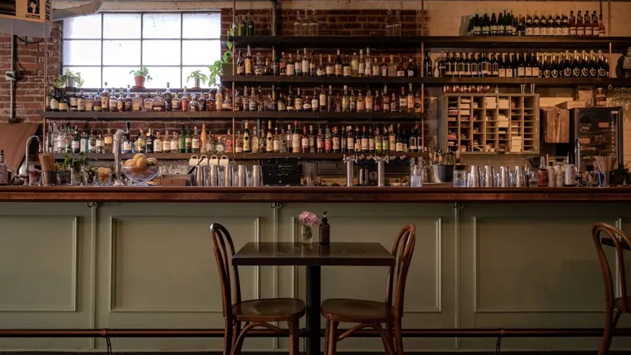 The back bar and cafe tables inside San Simón in downtown Bend