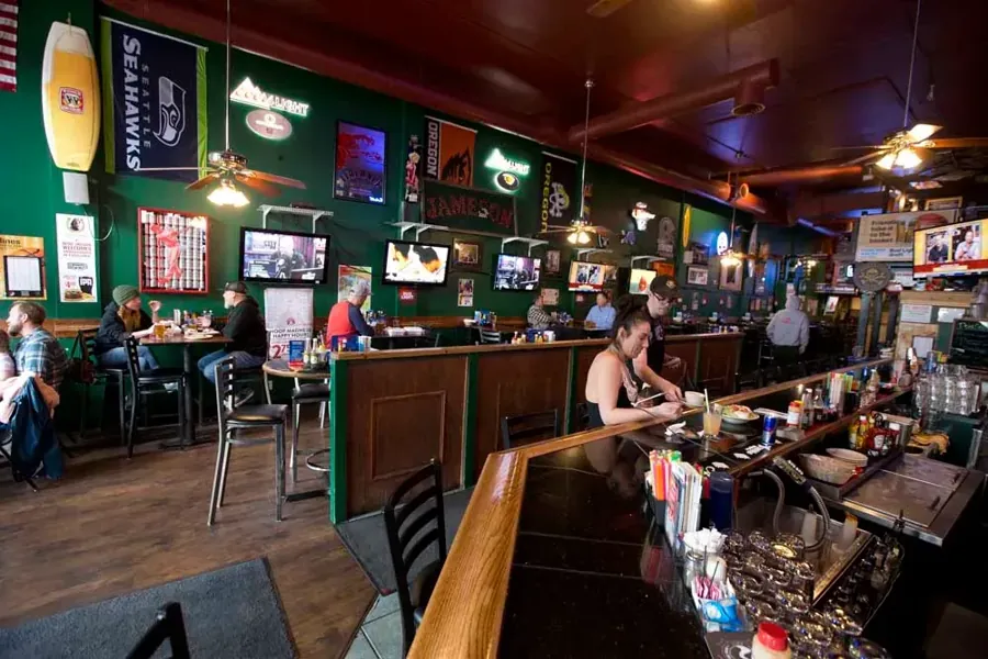 The bar and TVs inside Sidelines Sportsbar & Grill in downtown Bend
