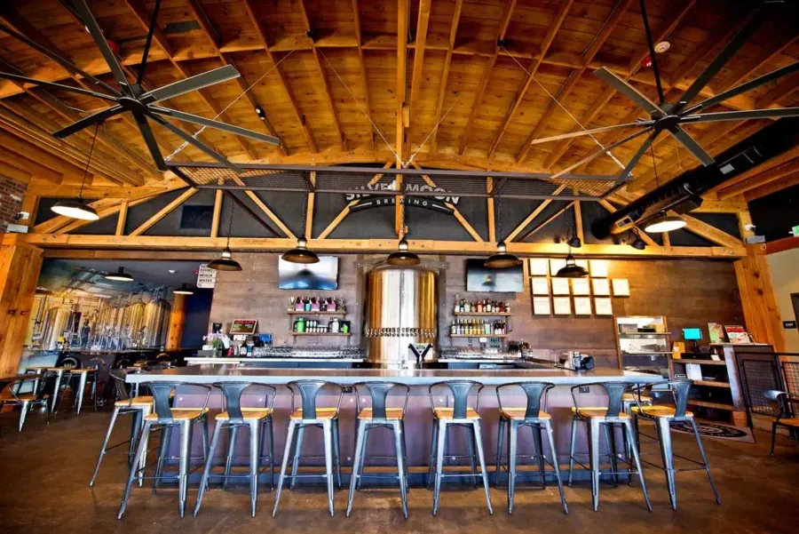 The bar and timber-beam ceiling inside the Silver Moon Brewing pub on Greenwood Avenue in Bend