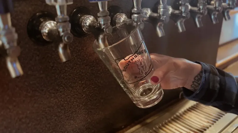 A beer being poured from the tap wall at Southside Pub in Bend