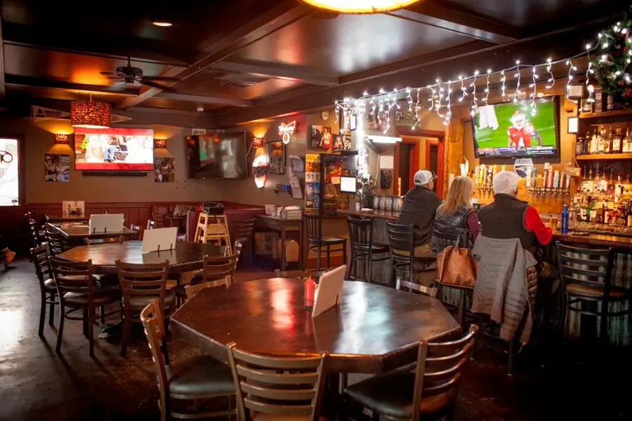 The dining room and TVs inside The Hideaway Tavern in Bend