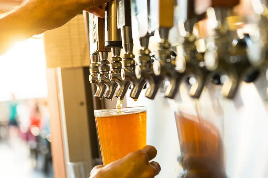 A beer being poured from the taps at The Lot food cart pod in Bend