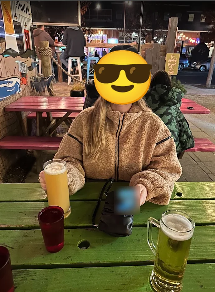 Beers on a green picnic table at The Podski food cart lot in Bend, Oregon on a cold night