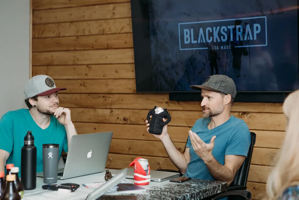 A small business team meeting around a table in a Bend office