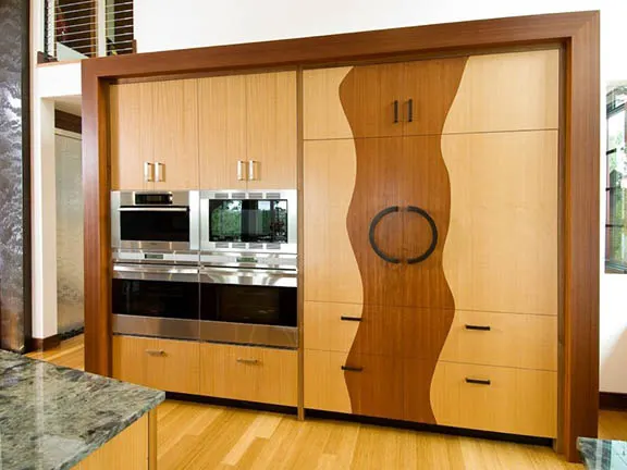 A sculpted wood pantry wall with curved doors by Ben's Cabinets in Sisters
