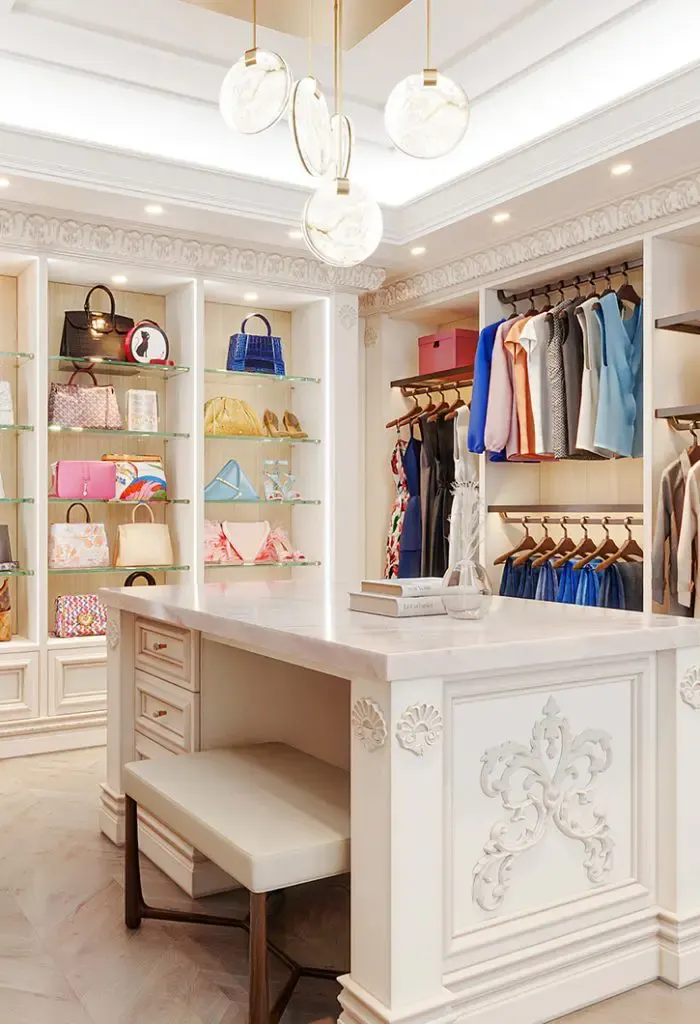 A white dressing room with built-in drawers and a vanity by Closet Factory