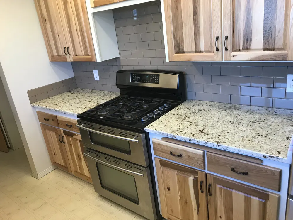 Rustic hickory cabinets with granite counters by Frank L Garrett Construction