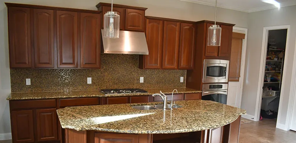 Kitchen with cherry-stained cabinets before painting