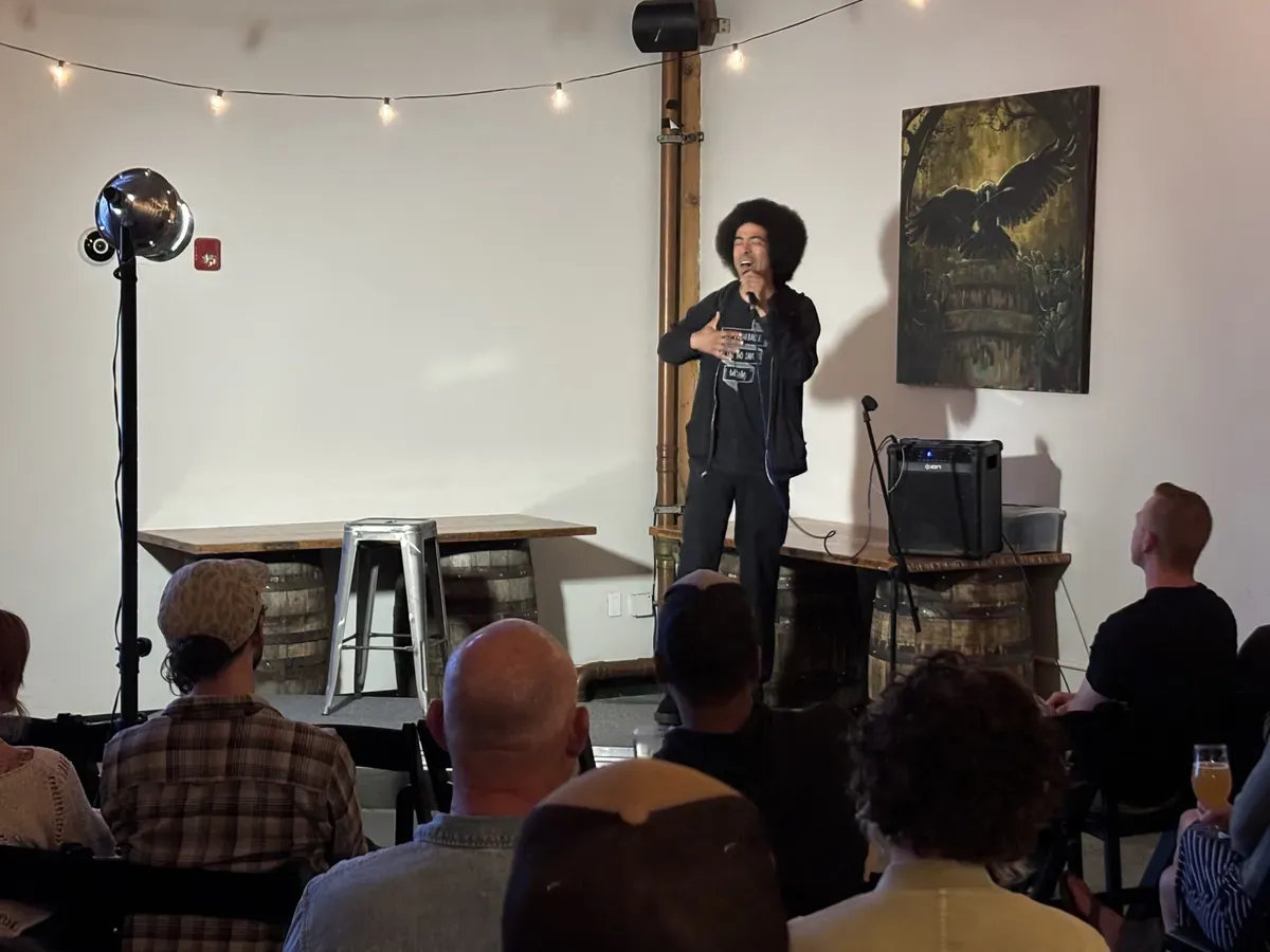 A local comic on stage in front of a Bend comedy crowd