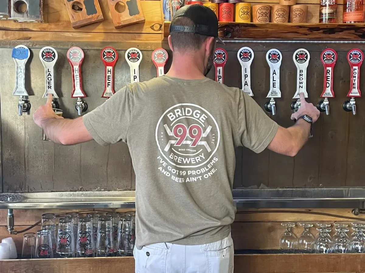 A bartender pulling beer from the taps at Bridge 99 Brewery