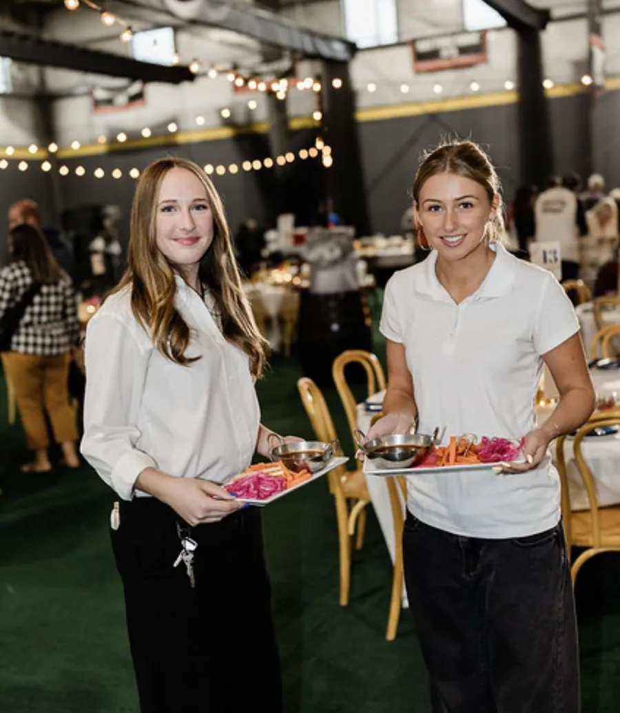 Craft Kitchen catering staff serving platters at an event