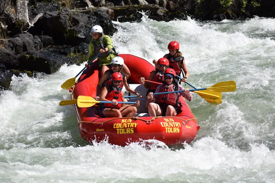 A Sun Country Tours raft crashing through whitewater on the Deschutes