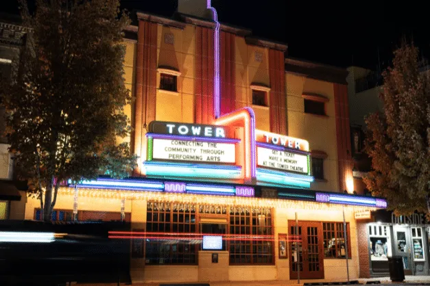 The lit marquee of the Tower Theatre on Wall Street at night