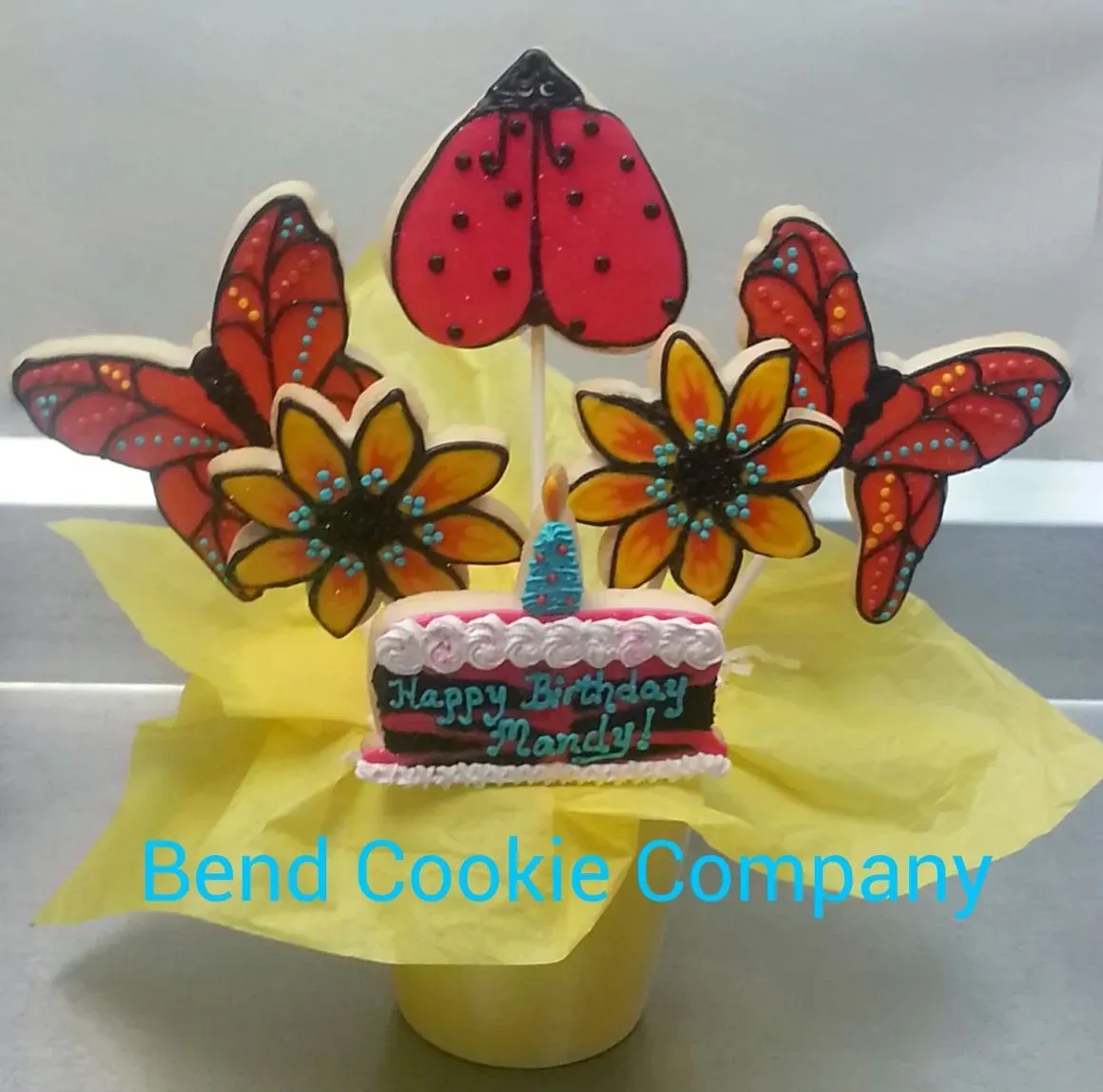 Hand-decorated flower and ladybug cookies from Bend Cookie Company