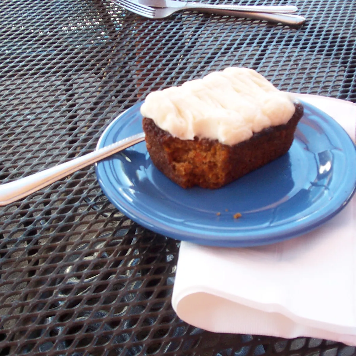 A slice of carrot cake with cream cheese frosting