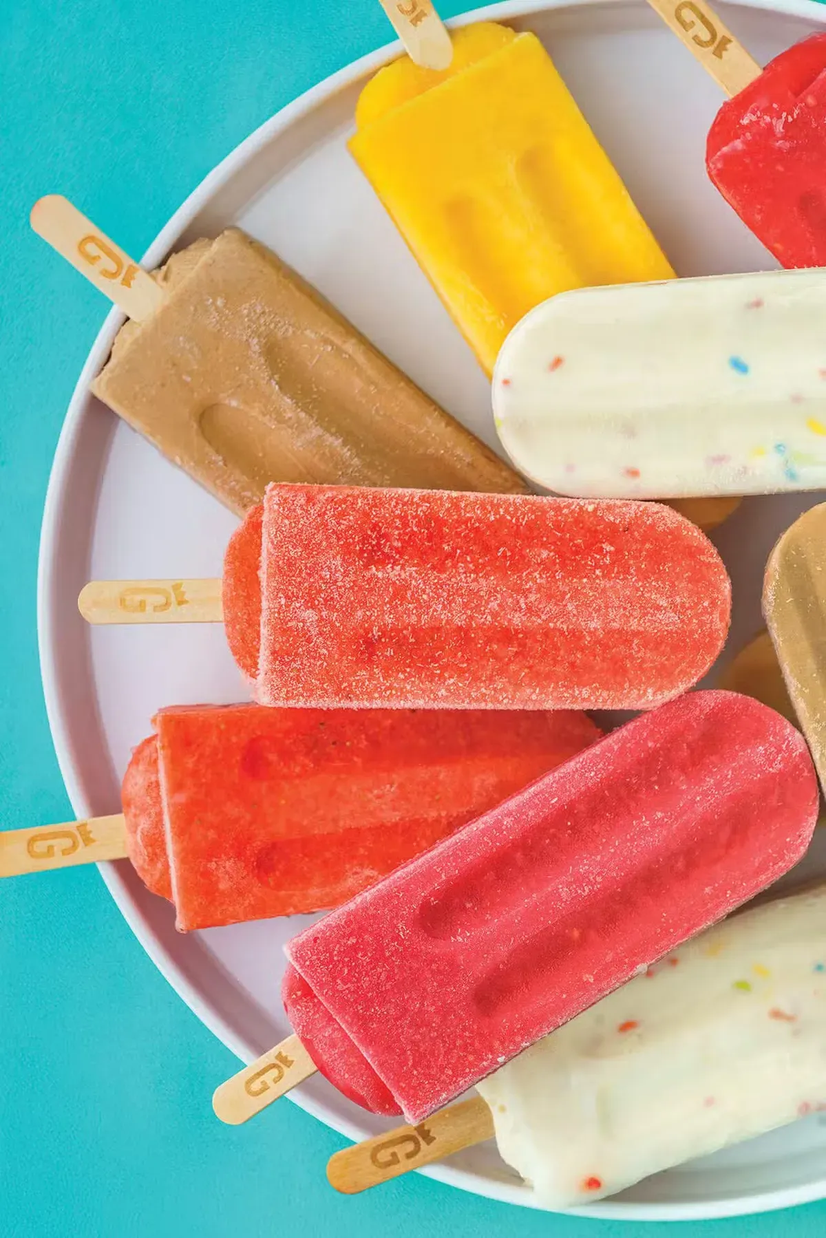 Bright fruit popsicles on a plate from Glory Gourmet Popsicles