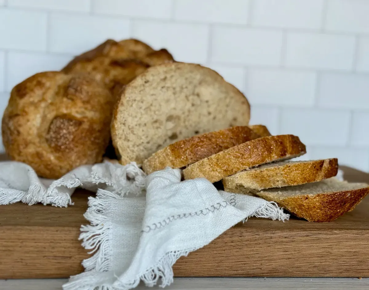 A loaf of gluten-free bread sliced on a board at Luce’s Bakehouse