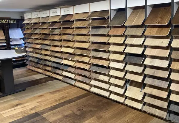Wall of hardwood flooring sample boards in a Bend showroom