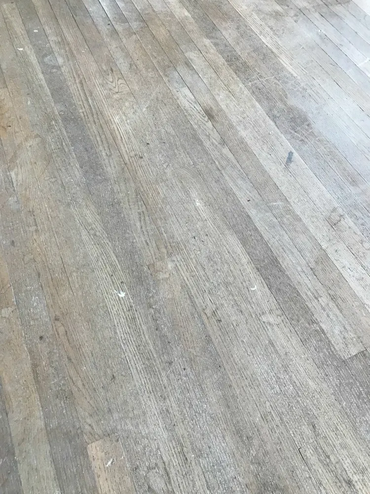Worn gray fir floorboards before refinishing