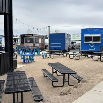Food trucks and picnic tables in the courtyard at Ballers & Brews in Bend, Oregon