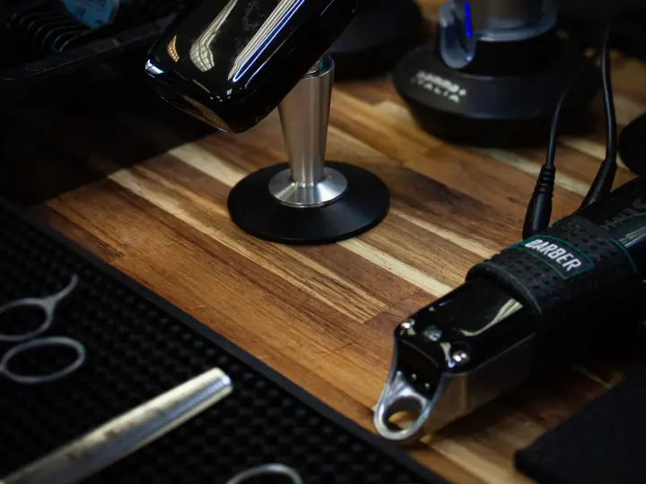 Clippers and scissors laid out at a barber station at Blade & Barrel in Bend