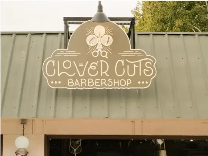 The Clover Cuts Barbershop sign above the shop on NW Hill Street in Bend