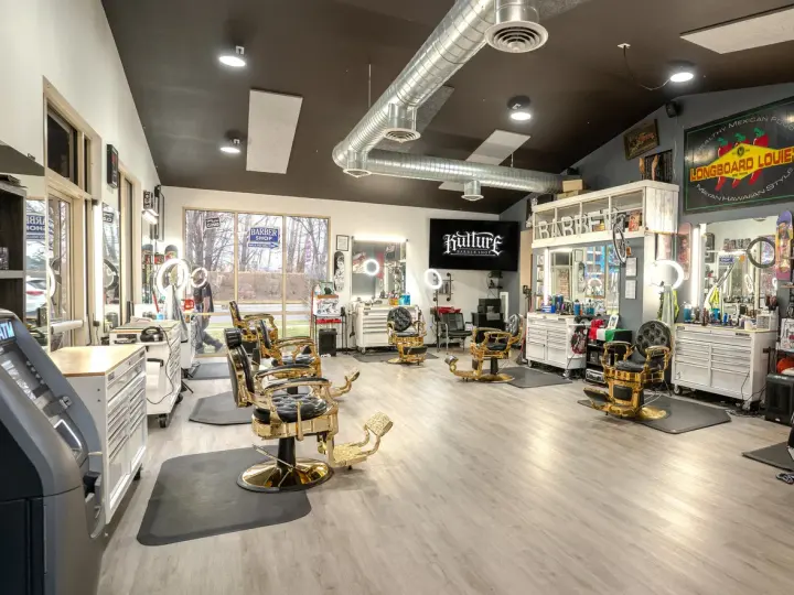 Bright interior of Kulture Barbershop in Bend with a row of barber chairs