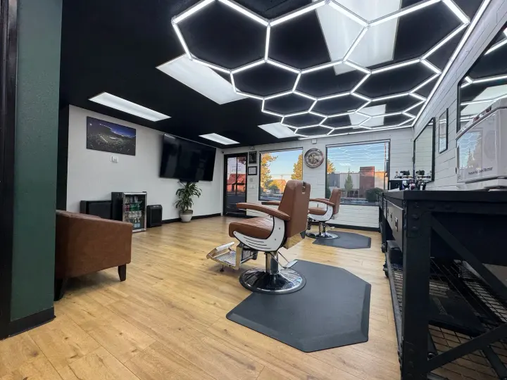 A barber chair under hexagon lights inside Tony’s Barbershop on NE 3rd Street