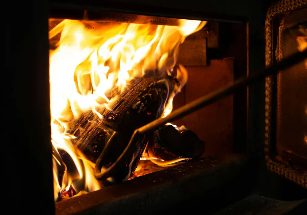Close-up of a hot wood fire burning in a stove firebox