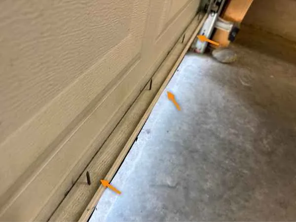 Sharp screw tips sticking out at the bottom of a garage door weatherstrip