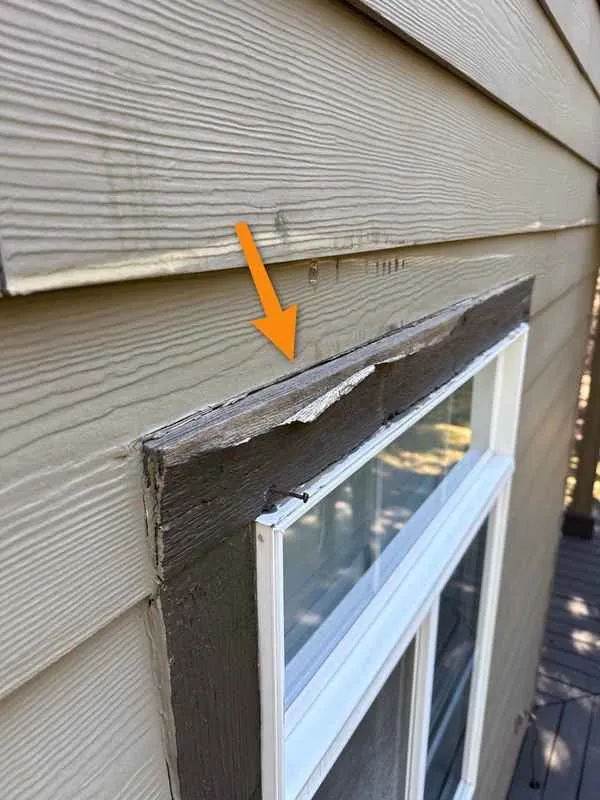 Swollen, peeling window trim with no metal header flashing above it