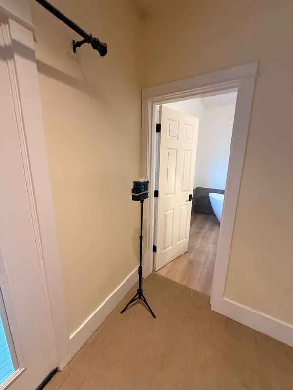 Mold air sampling pump on a tripod in a hallway