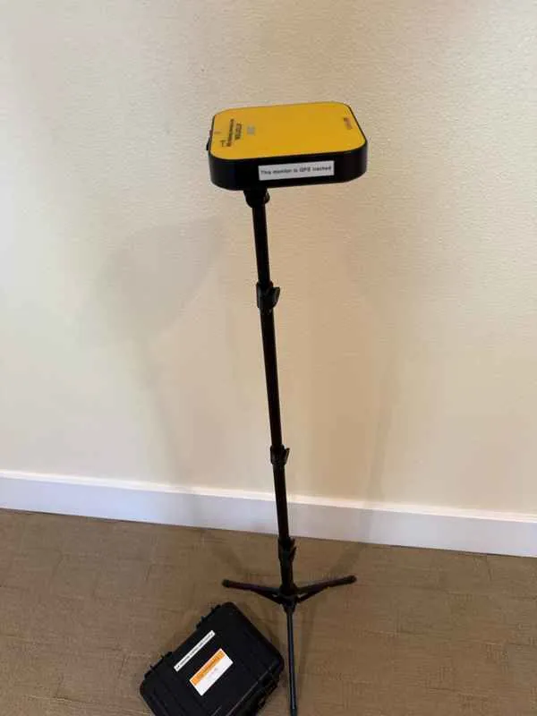 Electronic radon monitor on a tripod in a downstairs bedroom