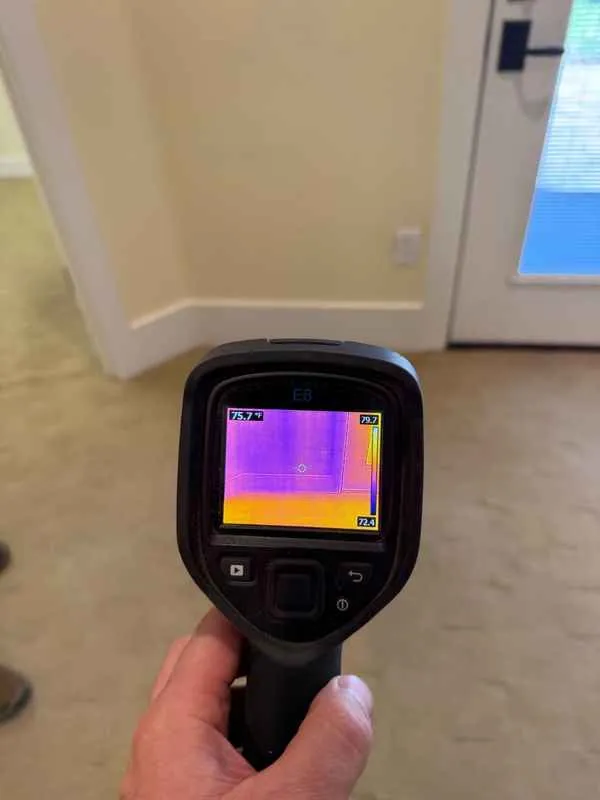 Thermal camera aimed at the swollen baseboard area by an exterior door