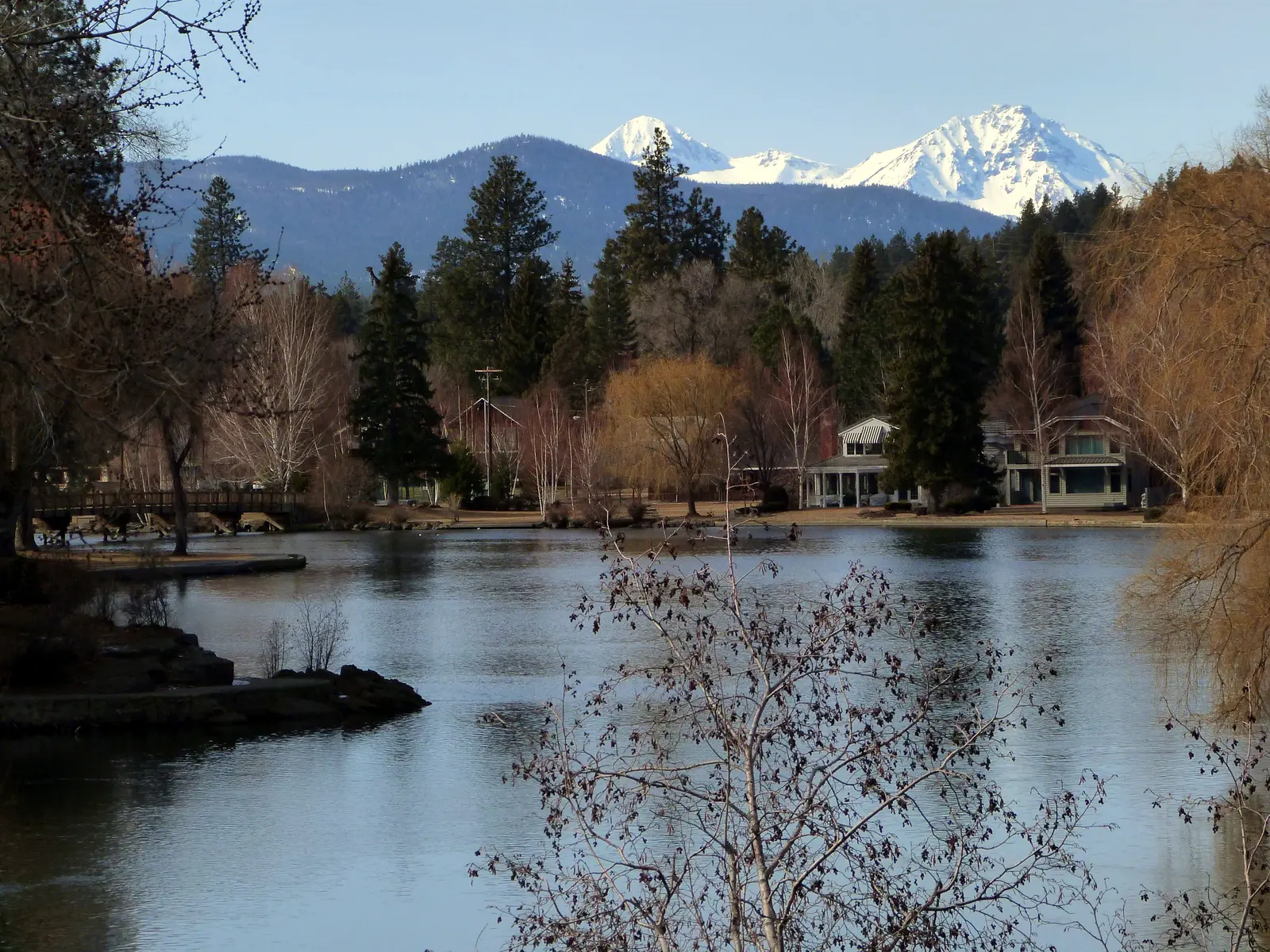 Mirror Pond in Bend with homes on the far bank and the snowy North and Middle Sister behind