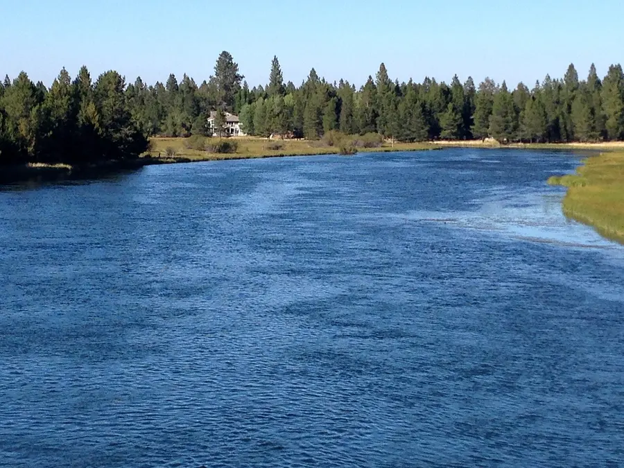 The wide, slow Deschutes River curving past ponderosa pines in Sunriver