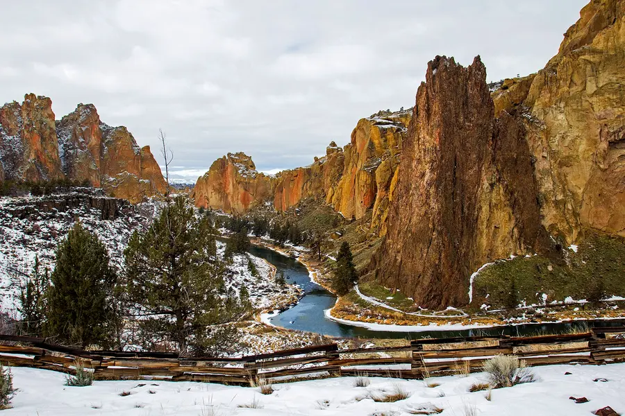A dusting of snow on Smith Rock’s orange cliffs above a bend of the Crooked River