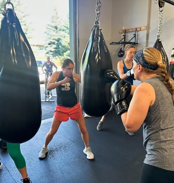 Women hitting heavy bags at BoXiT Fitness Studio