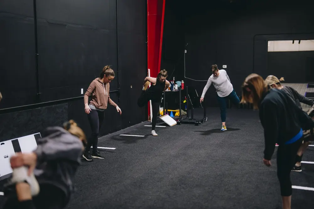 Adults training on the floor at Gym X