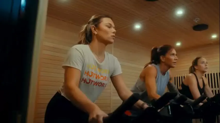 People riding bikes inside an infrared sauna studio