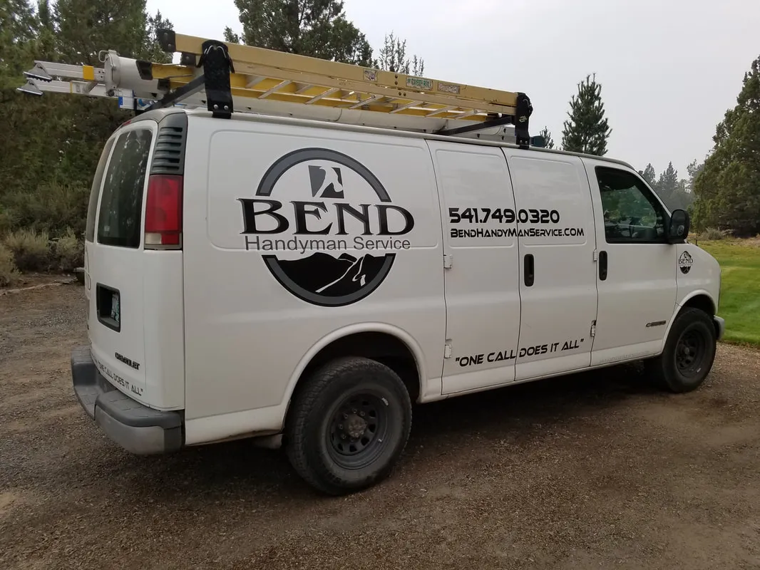 The Bend Handyman Service van parked among pines