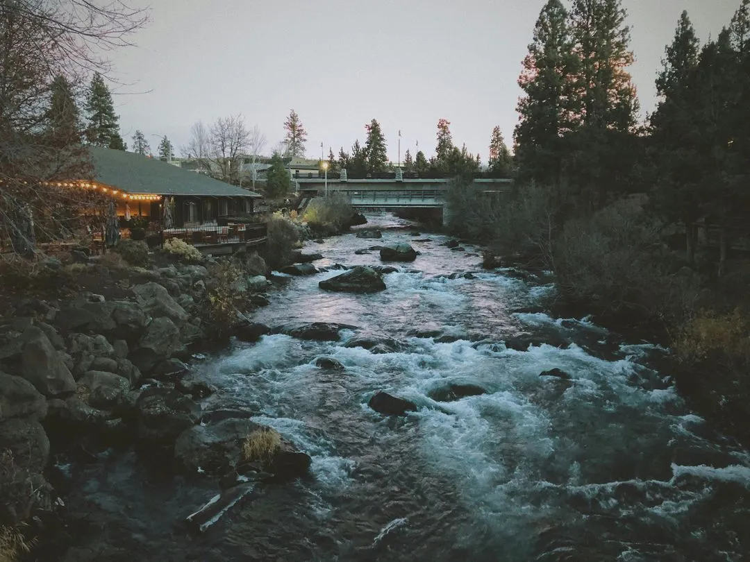 The Deschutes River running past homes in Bend